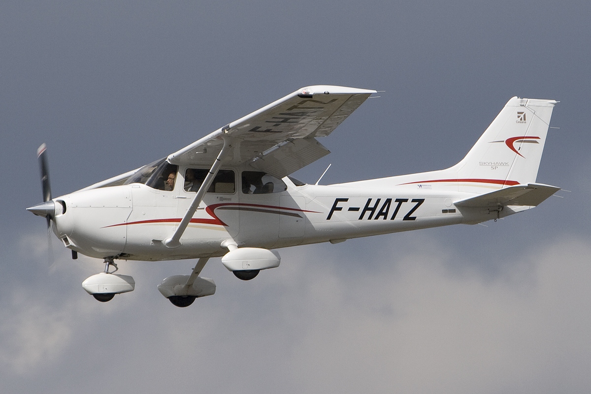 Cessna 172S Skyhawk flying against a cloudy sky