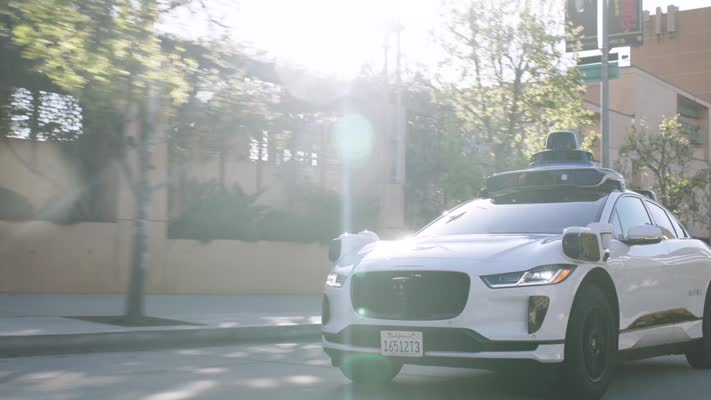 Waymo autonomous Jaguar I-PACE driving on a city street